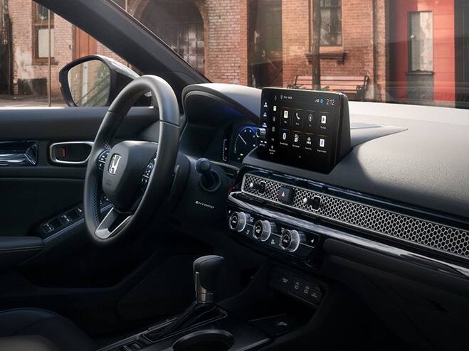 2027 Honda Civic Sedan Sport Touring Hybrid dashboard and center console view parked on a city street (Compact Sedan)